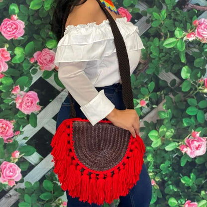 Side view of a female wearing a Burgundy Empanada Palm Purse with red tassels - DSY Lifestyle