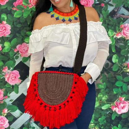 Close up of female wearing a Burgundy Empanada Palm Purse with red tassels - DSY Lifestyle