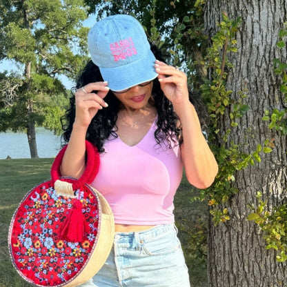 Woman posing and wearing a Light Denim Easily Distracted by Dogs Baseball Cap- DSY Lifestyle