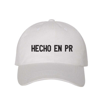 White embroidered baseball hat with &quot;Hecho En PR&quot; stitched in bold lettering, representing Puerto Rican pride and heritage - DSY Lifestyle