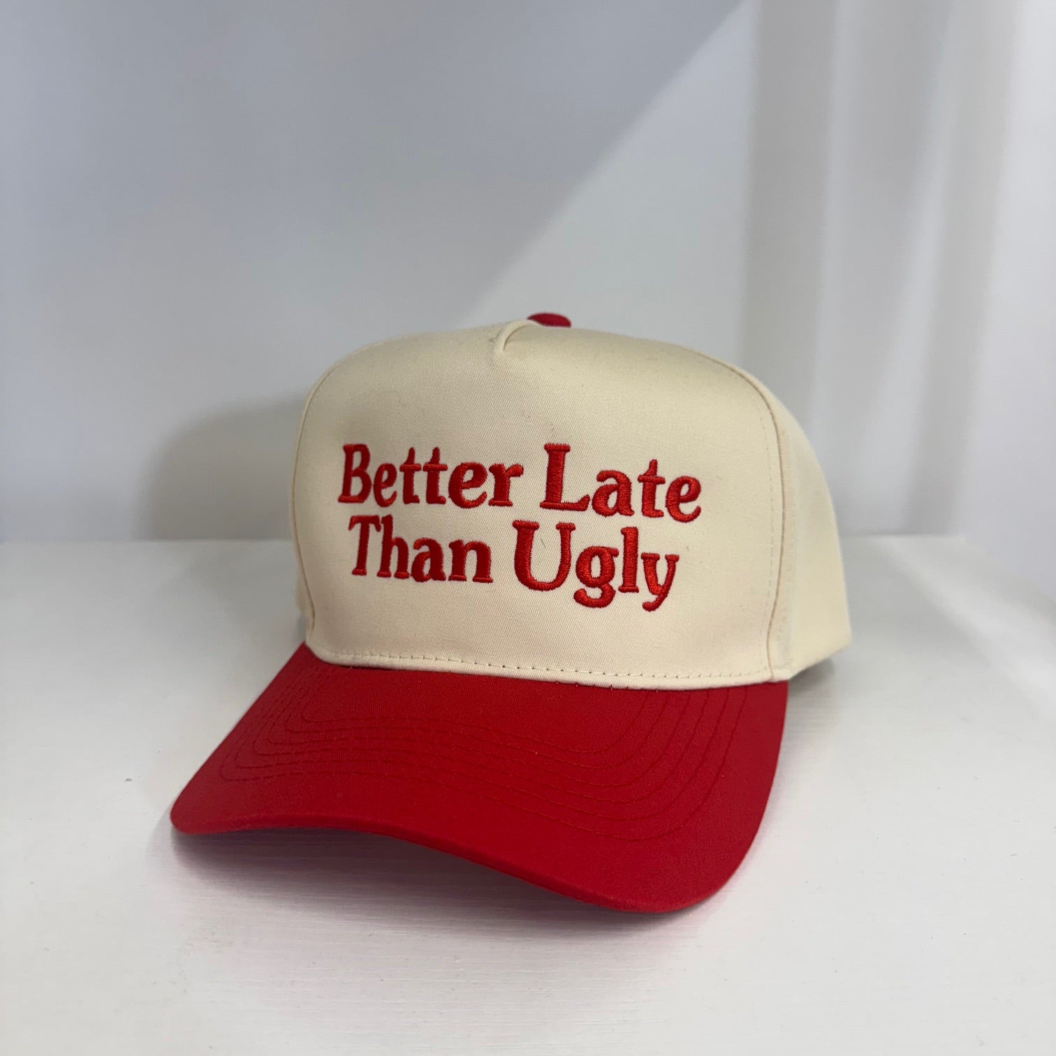 Natural colored 5 panel baseball hat with red bill embroidered with the phrase better late than ugly-DSY Lifestyle