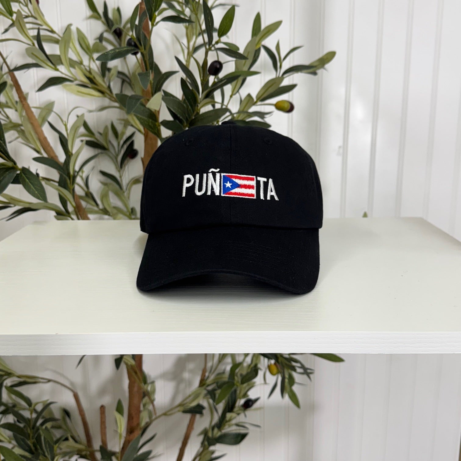 Black embroidered baseball hat with &quot;Puñeta&quot; in bold lettering, featuring the Puerto Rican flag as the letter &quot;E,&quot; representing Boricua pride and culture - DSY Lifestyle