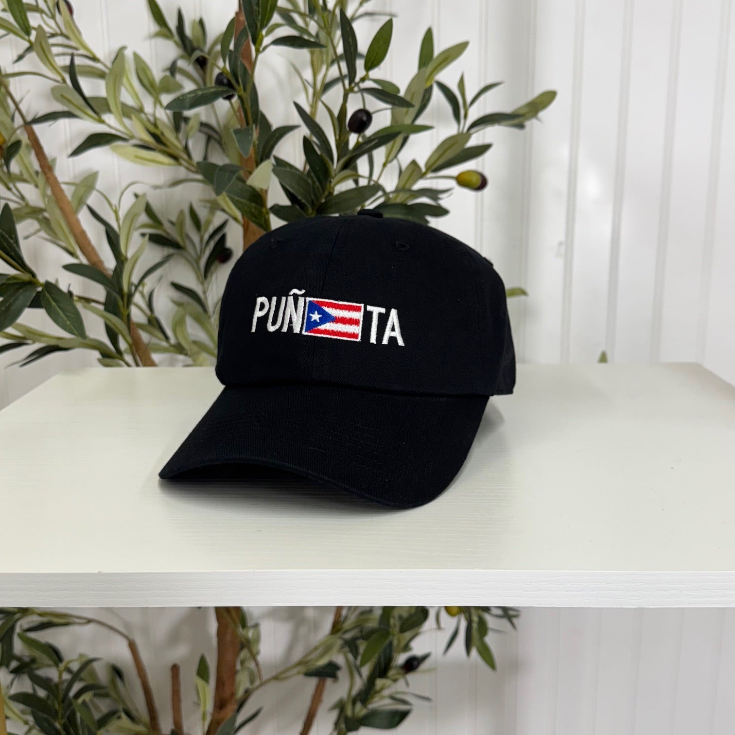 Black embroidered baseball hat with &quot;Puñeta&quot; in bold lettering, featuring the Puerto Rican flag as the letter &quot;E,&quot; representing Boricua pride and culture - DSY Lifestyle