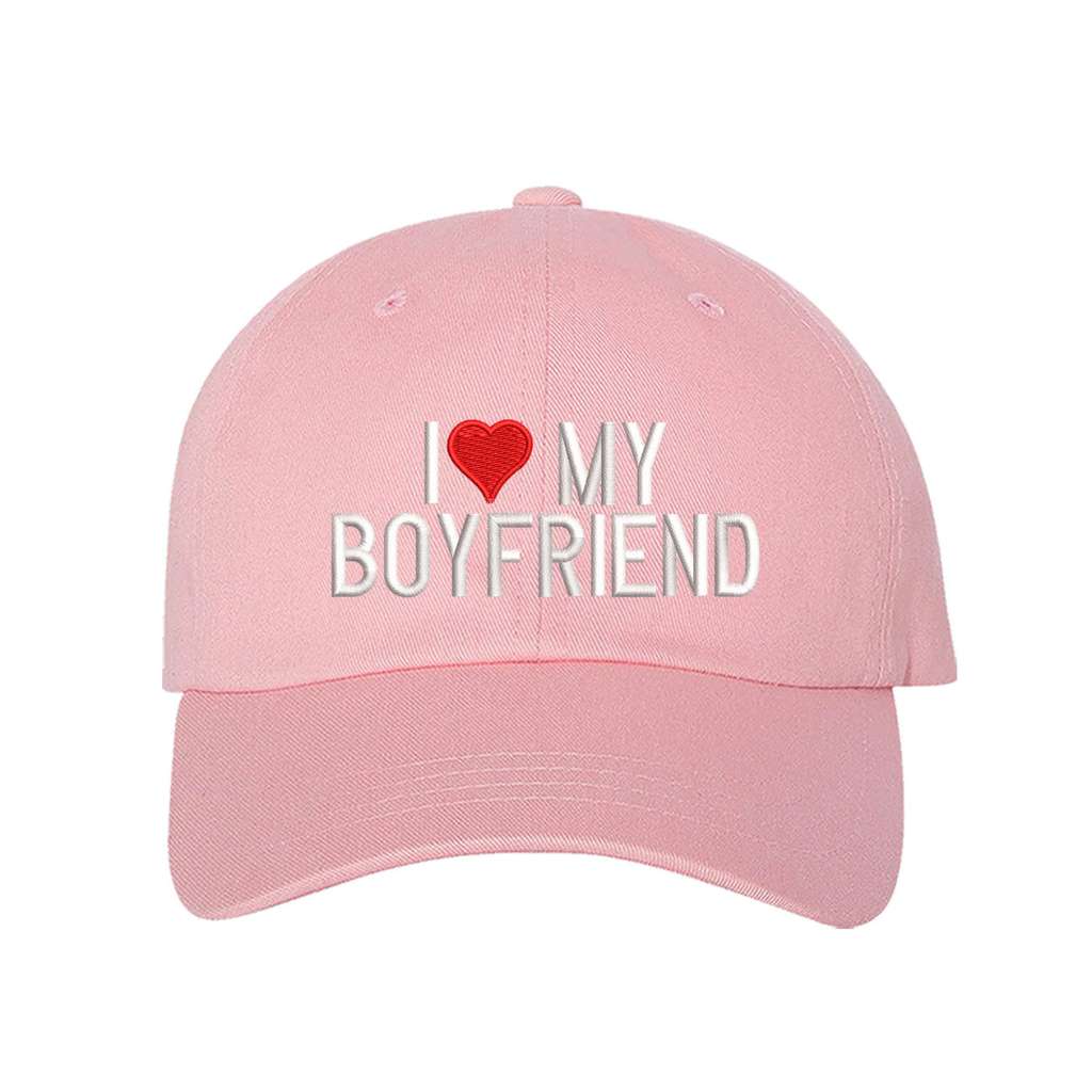 Light pink baseball hat embroidered with the phrase I love my boyfriend but love is a heart- DSY Lifestyle