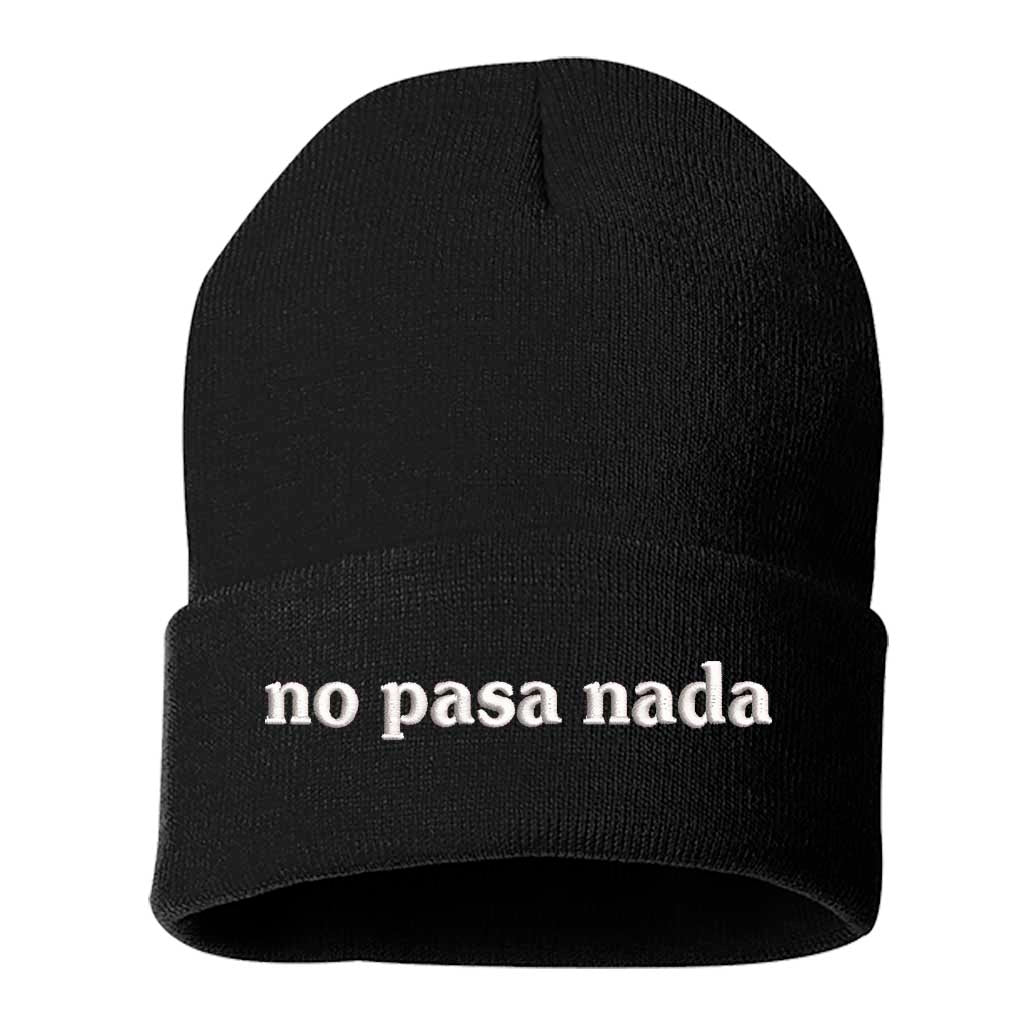 Flat lay of No Pasa Nada Spanglish BLACK beanie, a cozy winter hat with chill vibes