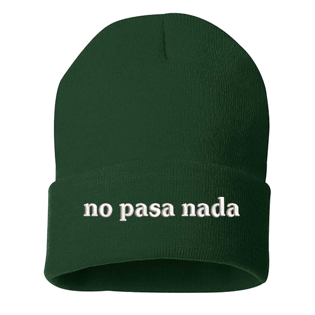 Flat lay of No Pasa Nada Spanglish Green beanie, a cozy winter hat with chill vibes