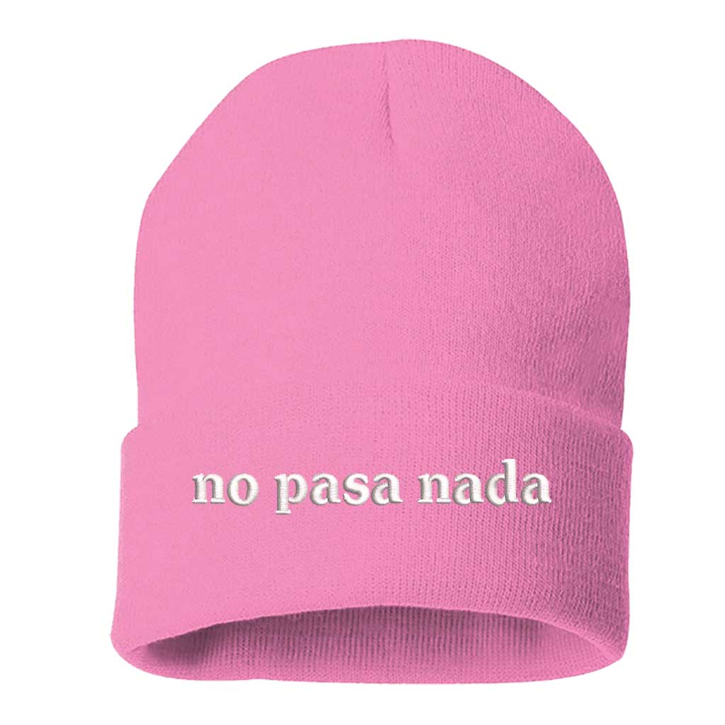 Flat lay of No Pasa Nada Spanglish pink beanie, a cozy winter hat with chill vibes