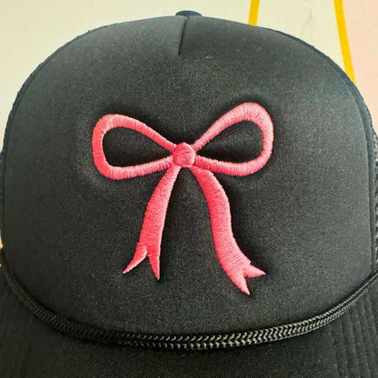 Close up of the embroidery of a Black foam trucker hat with an embroidered Pink Coquette Bow - DSY Lifestyle