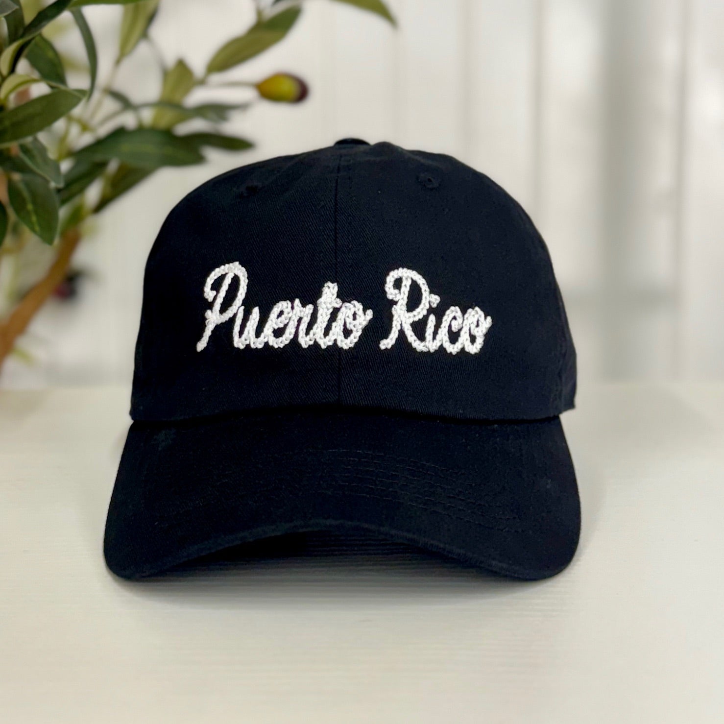 Black baseball hat with Puerto Rico embroidered in chain stitch cursive, combining vintage charm with modern island pride - DSY Lifestyle