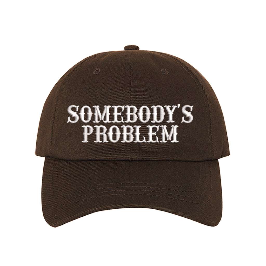 Brown baseball hat embroidered with the phrase somebody&