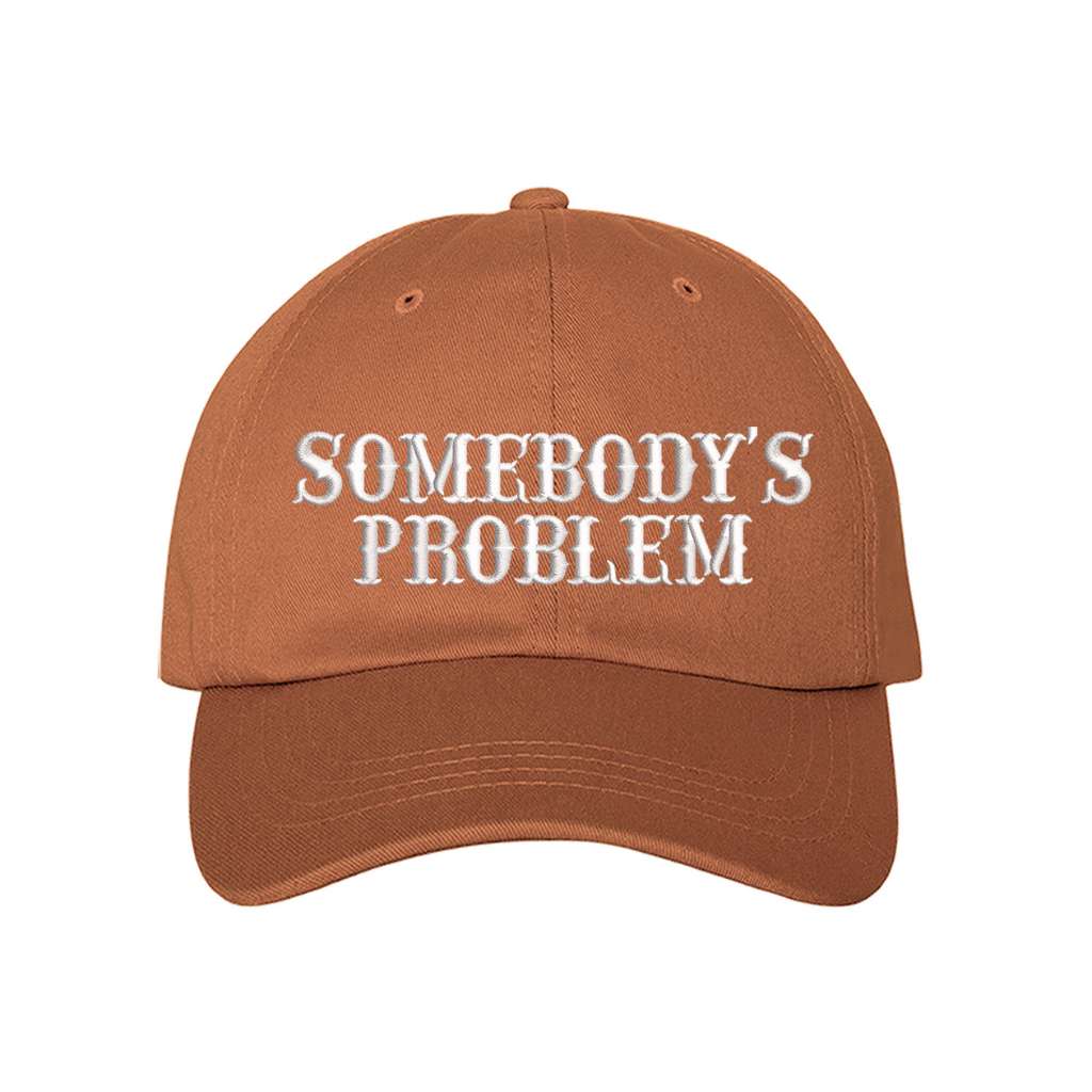 Burnt Orange baseball hat embroidered with the phrase somebody&