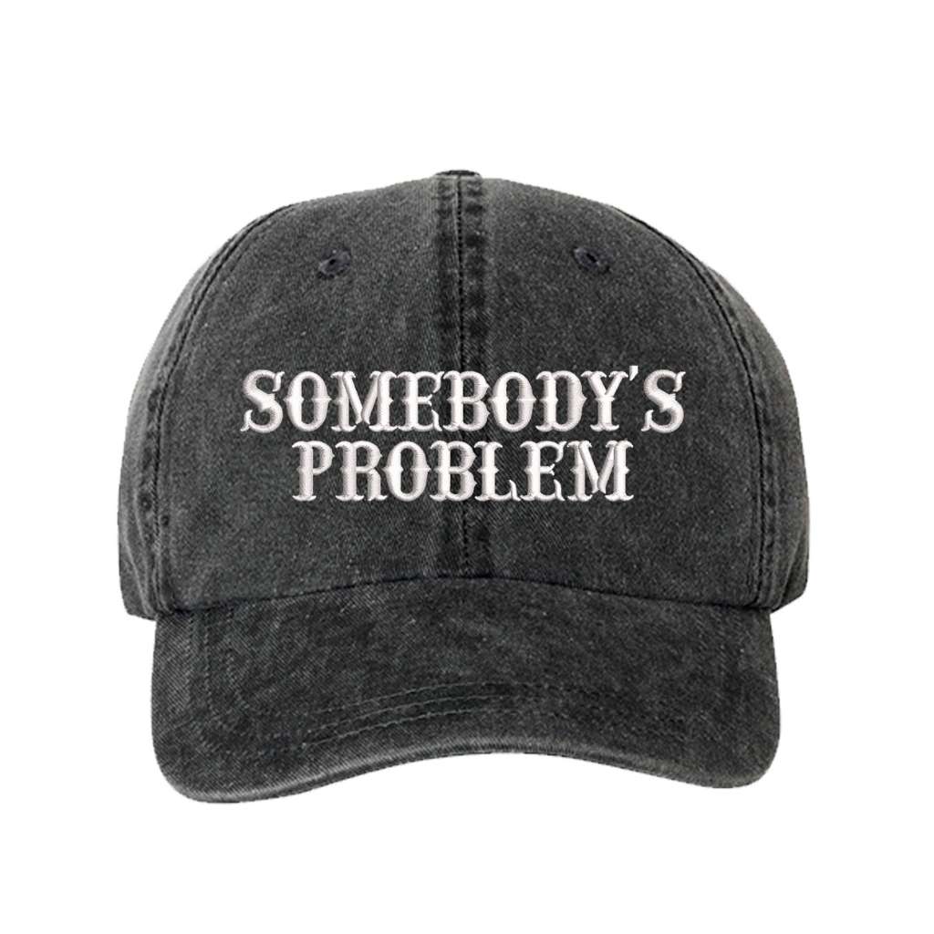 Washed black baseball hat embroidered with the phrase somebody&