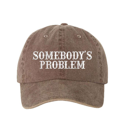 Washed Brown baseball hat embroidered with the phrase somebody&