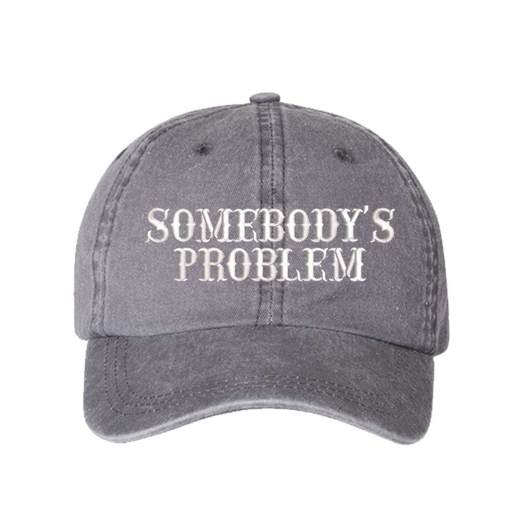 Washed Grey baseball hat embroidered with the phrase somebody&