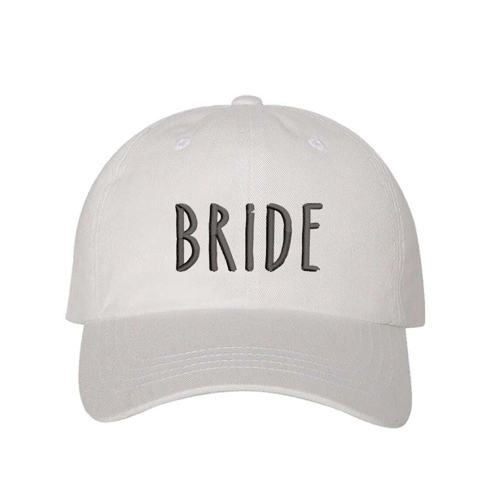 White embroidered baseball hat with Bride stitched in elegant script, ideal for bachelorette parties, wedding planning, and honeymoon outfits - DSY Lifestyle