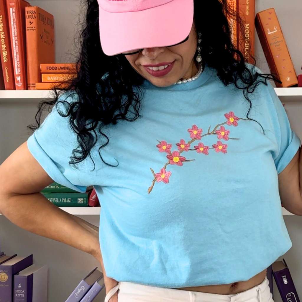 Female wearing a blue shirt embroidered with a cherry blossom - DSY Lifestyle