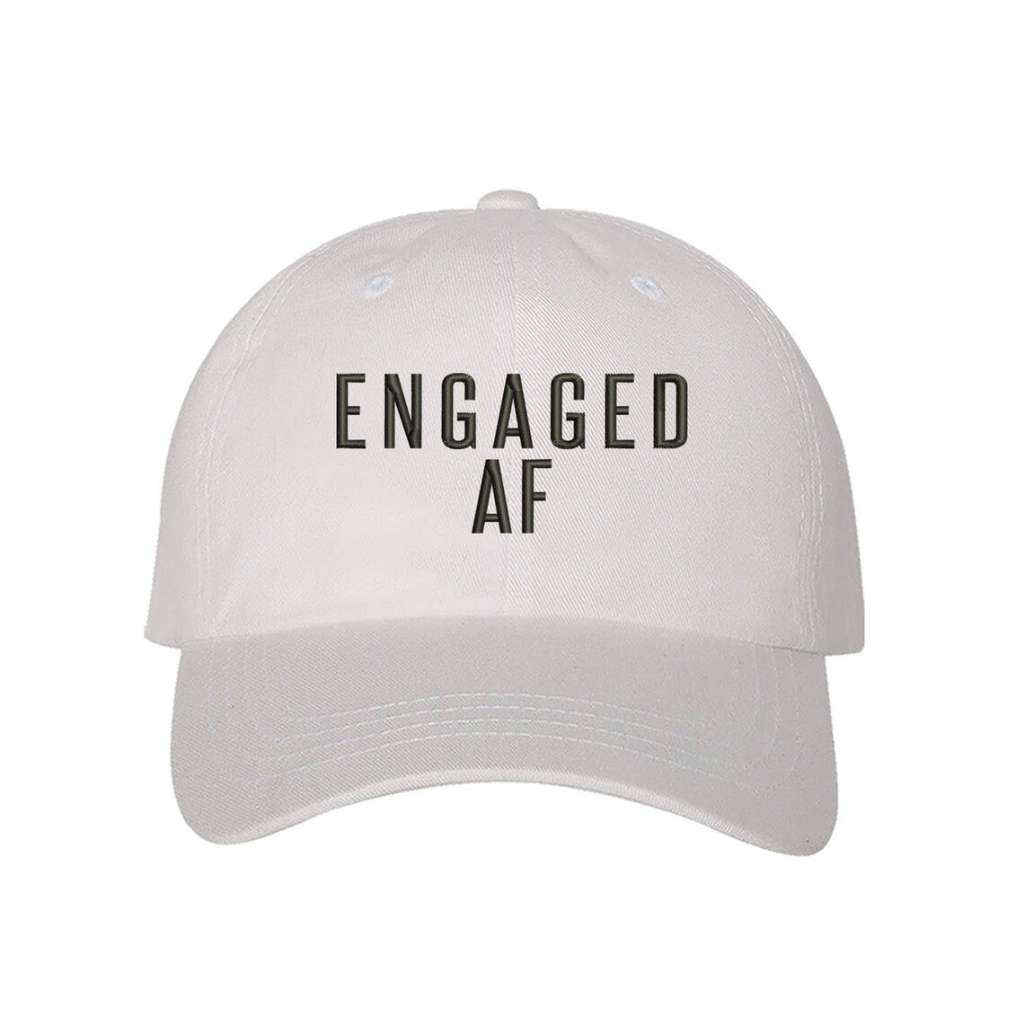 White trendy embroidered baseball hat  with Engaged AF text, perfect for newly engaged brides-to-be celebrating their upcoming  wedding - DSY Lifestyle