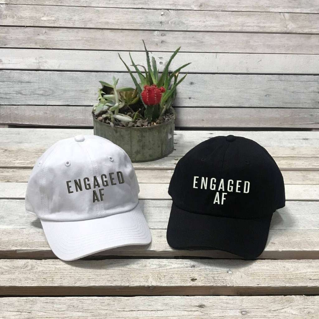 One Black and one White set of trendy embroidered baseball hats  with Engaged AF text, perfect for newly engaged brides-to-be celebrating their upcoming wedding - DSY Lifestyle