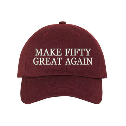 Burgundy stylish baseball hat with Make Fifty Great Again embroidered on the front, featuring an adjustable strap and soft cotton fabric for a comfortable and classic fit - DSY Lifestyle