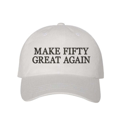 White stylish baseball hat with Make Fifty Great Again embroidered on the front, featuring an adjustable strap and soft cotton fabric for a comfortable and classic fit - DSY Lifestyle