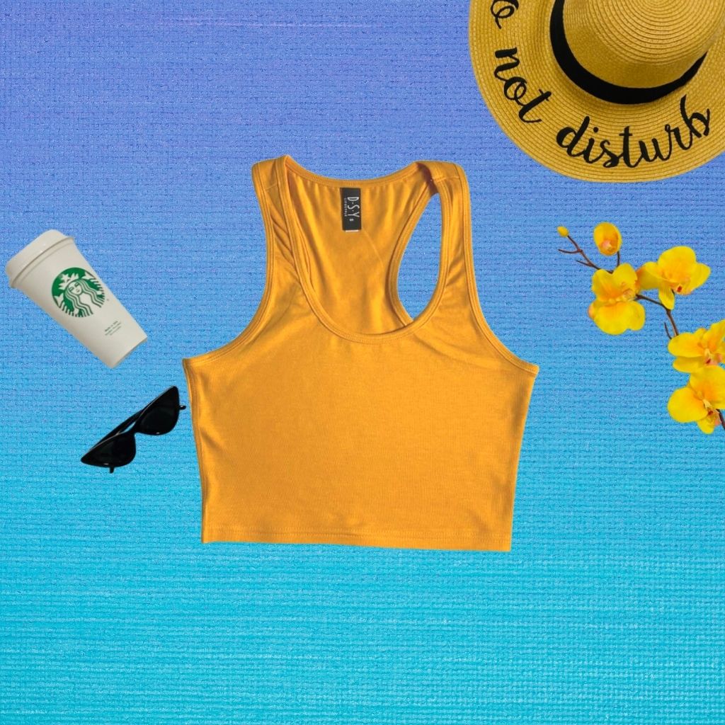 flat lay of mustard color racerback crop top - DSY Lifestyle