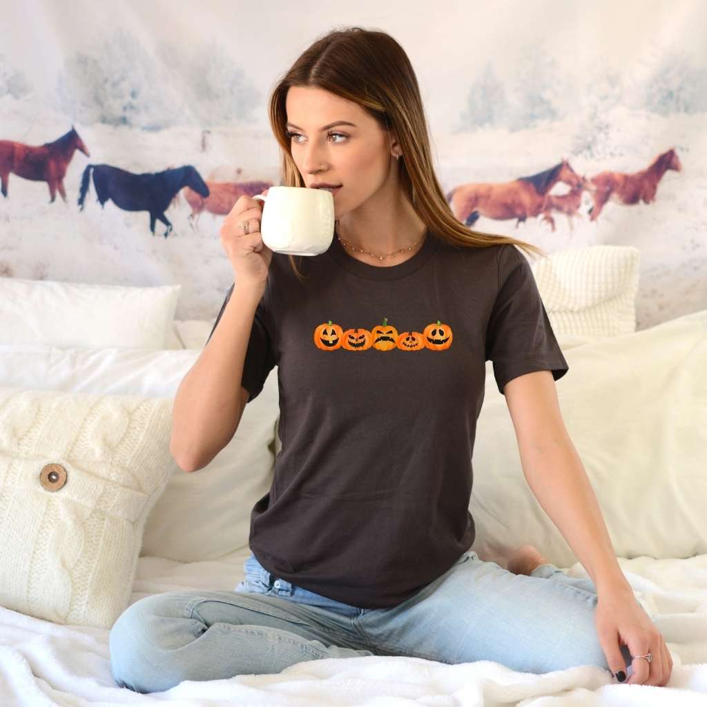 Female wearing a brown Unisex T-shirt with 5 pumpkin printed in the front - DSY Lifestyle