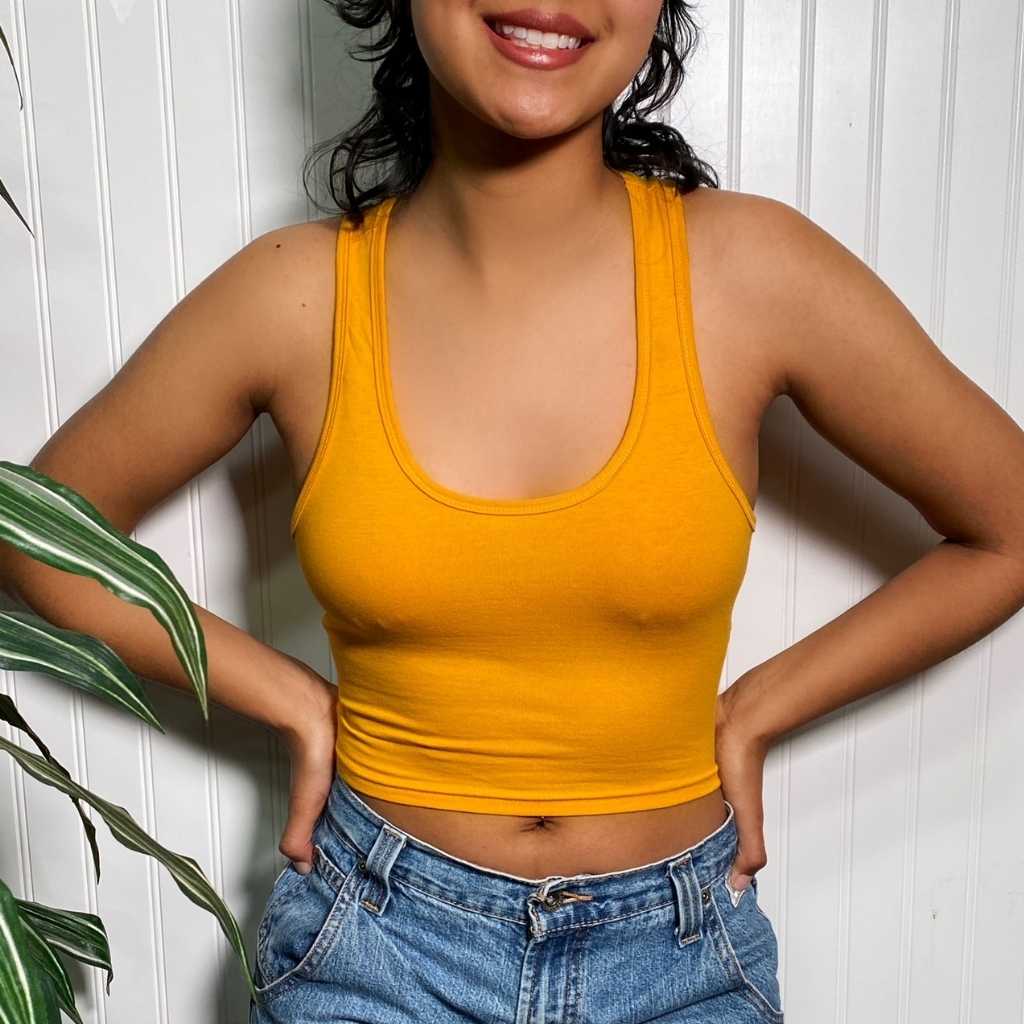 female wearing a mustard color Racerback crop tank top and denim jeans-DSY Lifestyle